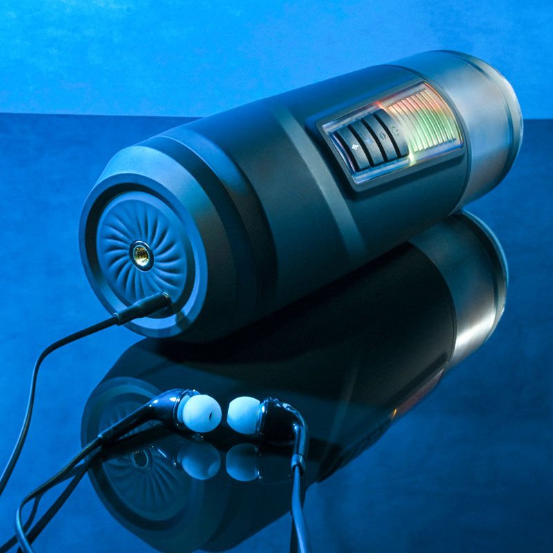 Topside view of the Gender X Message in a Bottle Stroker Male Masturbator highlighting the magnetic charging port, presented on a blue decorative background. | Flirty Bay adult store Perth